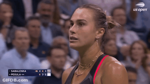 A Woman Stands In Front Of A Screen That Says Us Open GIF