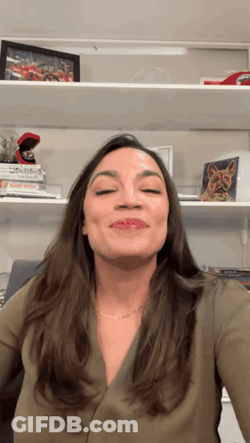 A Woman Stands In Front Of A Shelf With A Picture Of A Ring On It GIF