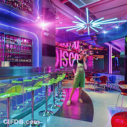 A Woman Stands In Front Of A Sign That Says Disco GIF