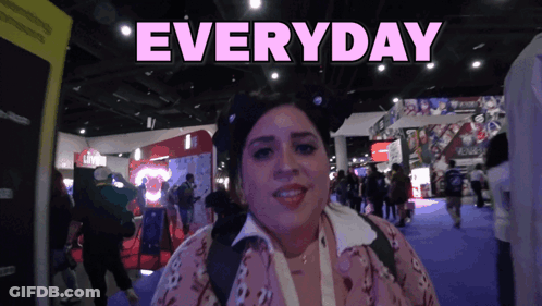 A Woman Stands In Front Of A Sign That Says Everyday On It GIF