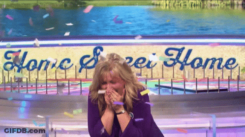 A Woman Stands In Front Of A Sign That Says " Home Sweet Home " GIF