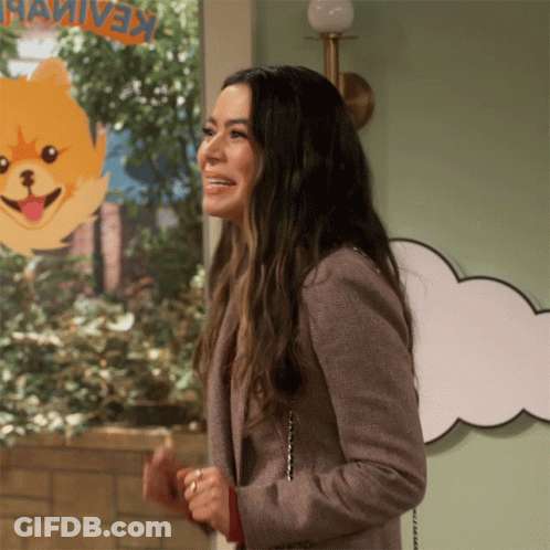 A Woman Stands In Front Of A Sign That Says Keaivex GIF