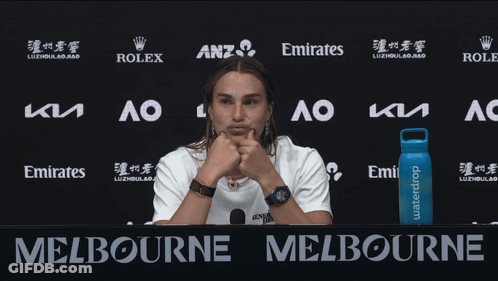 A Woman Stands In Front Of A Sign That Says Melbourne On It GIF