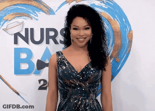 A Woman Stands In Front Of A Sign That Says Nurses Ba GIF