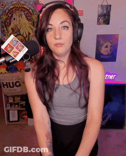 A Woman Stands In Front Of A Sign That Says " This Cushion Contains A Hug " GIF