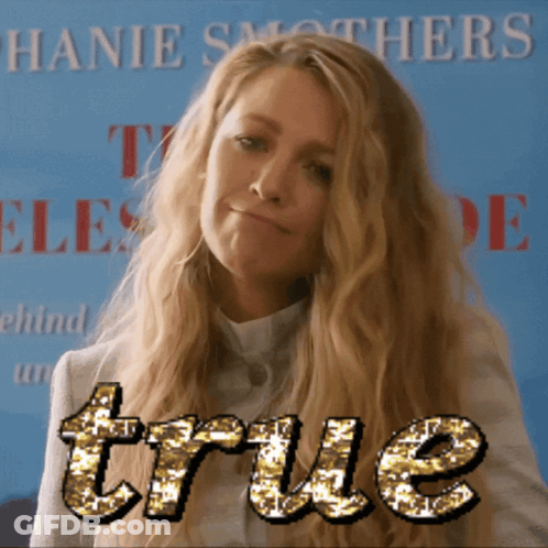 A Woman Stands In Front Of A Sign That Says " True " GIF