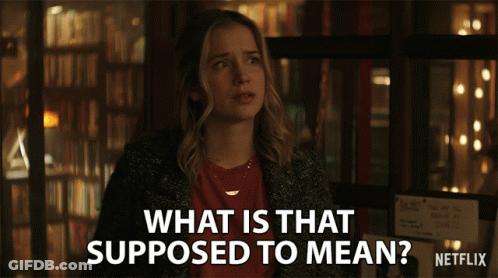 A Woman Stands In Front Of A Sign That Says What Is That Supposed To Mean Netflix GIF