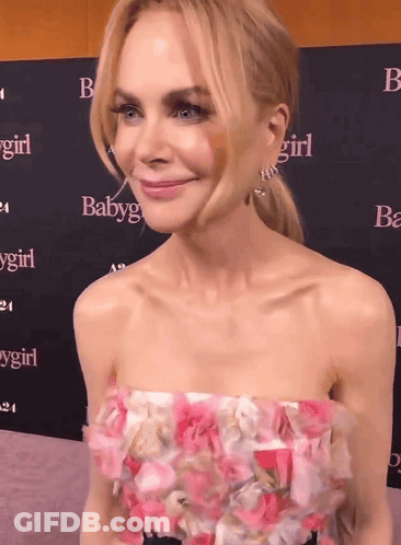 A Woman Stands In Front Of A Wall That Says Baby Girl GIF