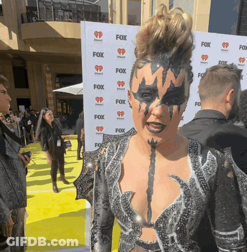 A Woman Stands In Front Of A Wall That Says Fox On It GIF