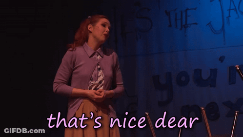 A Woman Stands In Front Of A Wall That Says ' That 'S Nice Dear ' GIF