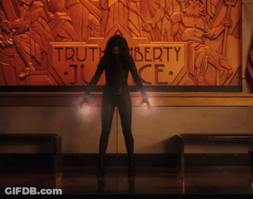 A Woman Stands In Front Of A Wall With A Sign That Says Truth Liberty Justice GIF