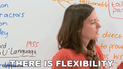 A Woman Stands In Front Of A White Board With The Words " There Is Flexibility " On It GIF