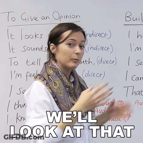 A Woman Stands In Front Of A White Board With The Words " We 'Ll Look At That " Written On It GIF