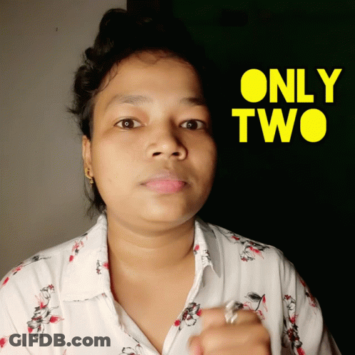 A Woman Stands In Front Of A Yellow Sign That Says Only Two GIF