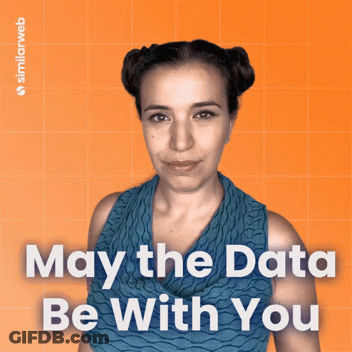 A Woman Stands In Front Of An Orange Background With The Words May The Data Be With You On It GIF