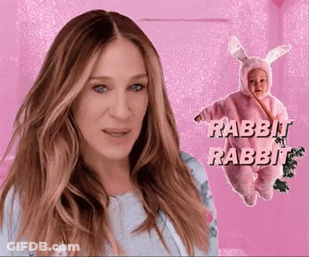A Woman Stands Next To A Baby Dressed In A Rabbit Costume GIF