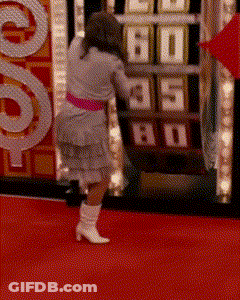 A Woman Stands On A Red Carpet In Front Of A Machine That Says 60 GIF