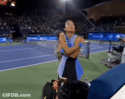 A Woman Stands On A Tennis Court With Her Arms Crossed In Front Of A Pepsi Banner GIF