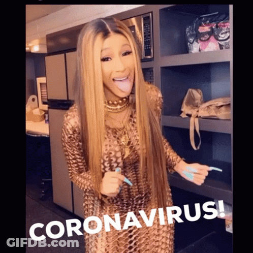 A Woman Sticking Her Tongue Out In Front Of A Sign That Says Coronavirus On It GIF