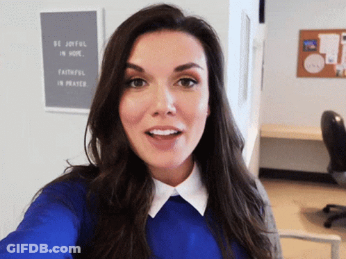 A Woman Takes A Selfie In Front Of A Sign That Says Be Joyful In Hope GIF
