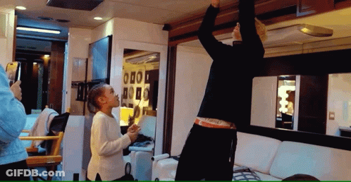 A Woman Taking A Picture Of A Man In A Van GIF