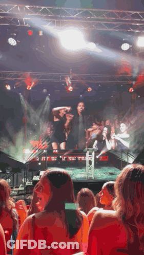 A Woman Taking A Picture Of A Stage With The Word Exit On It GIF