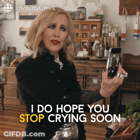 A Woman Taking A Picture Of Herself With The Words I Do Hope You Stop Crying Soon Below Her GIF