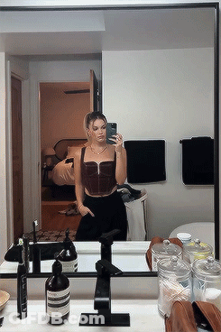 A Woman Taking A Selfie In Front Of A Bathroom Mirror GIF