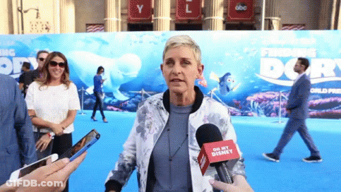 A Woman Talking Into A Microphone That Says Oh My Disney On It GIF