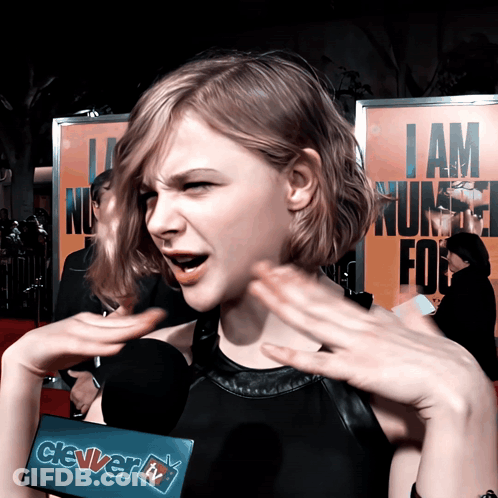 A Woman Talking Into A Microphone With A Sign That Says Clever Tv On It GIF
