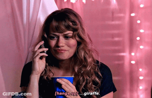 A Woman Talking On A Cell Phone While Holding A Blue Cup That Says Hang Up Giraffe GIF