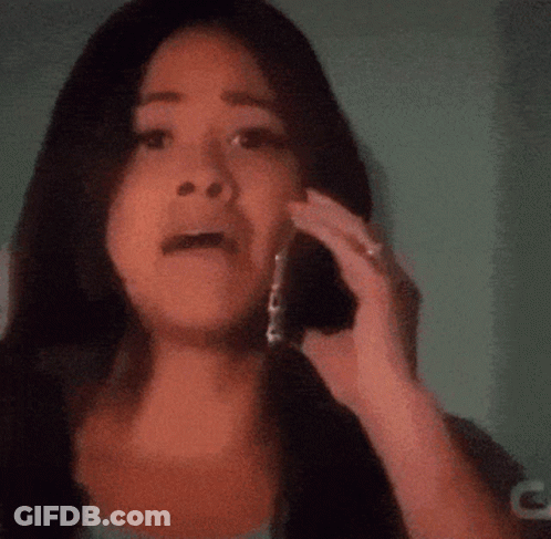 A Woman Talking On A Cell Phone With A Blurred Background GIF