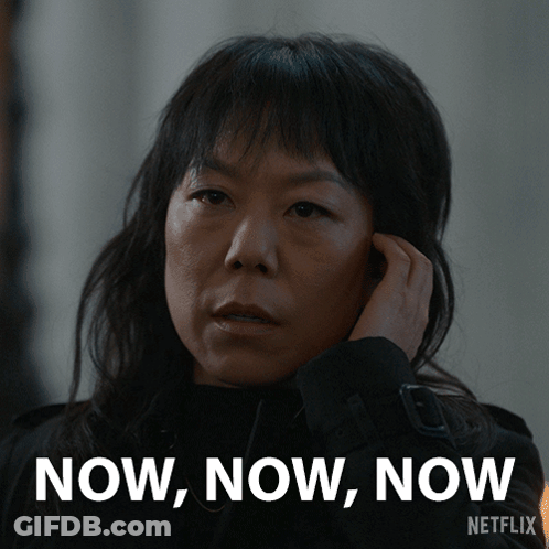 A Woman Talking On A Cell Phone With The Words Now Now Now Written On The Bottom GIF