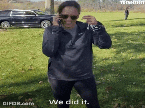 A Woman Talking On A Cell Phone With The Words " We Did It " Written On The Bottom GIF