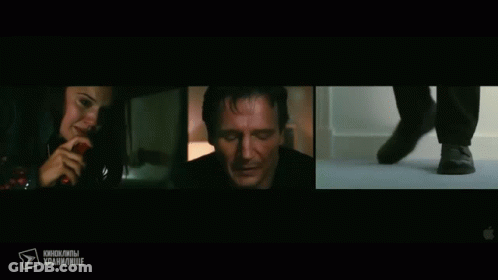 A Woman Talking On A Phone Next To A Man In A Dark Room GIF