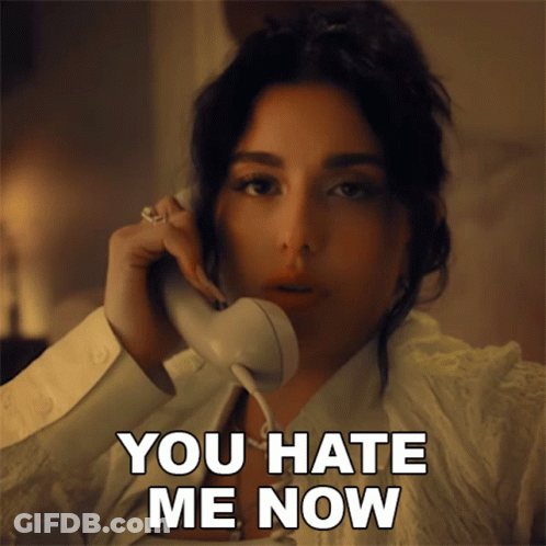 A Woman Talking On A Phone With The Words " You Hate Me Now " Next To Her GIF