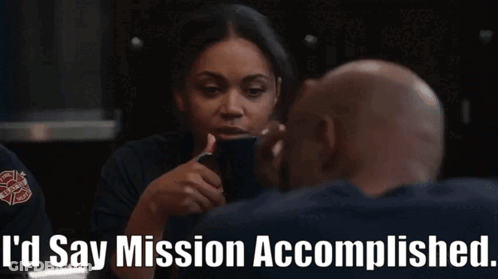A Woman Talking To A Man With The Words " I 'D Say Mission Accomplished " On The Bottom GIF