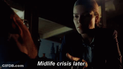 A Woman Talking To A Man With The Words Midlife Crisis Later GIF