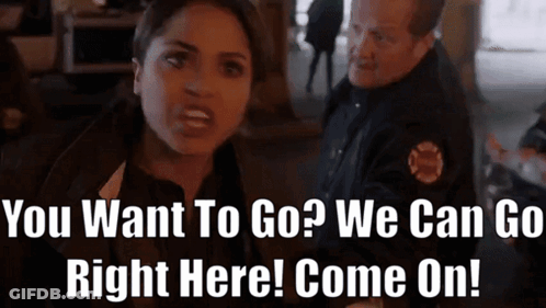 A Woman Talking To A Police Officer With The Words " You Want To Go ? We Can Go Right Here Come On ! " GIF
