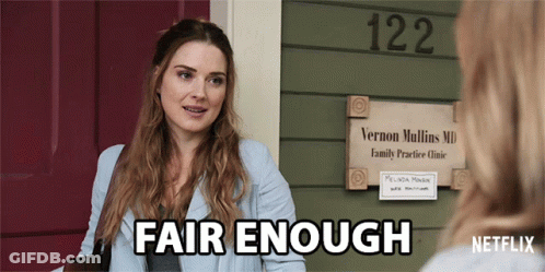 A Woman Talking To Another Woman In Front Of A Sign For Vernon Mullins Md GIF