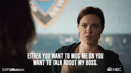 A Woman Talking To Another Woman With Either You Want To Mug Me Or You Want To Talk About My Boss Written Below Her GIF