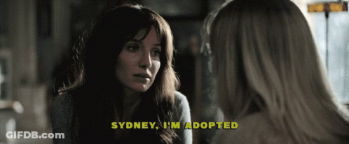 A Woman Talking To Another Woman With The Words Sydney I 'M Adopted Above Her GIF