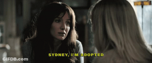 A Woman Talking To Another Woman With The Words Sydney I 'M Adopted Above Her GIF