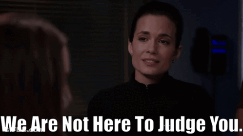 A Woman Talking To Another Woman With The Words " We Are Not Here To Judge You " Below Her GIF