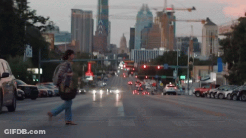 Woman Walking City Street With A Sign GIF