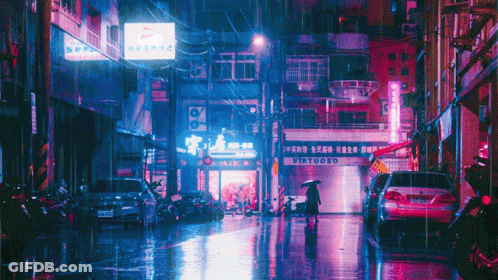 A Woman Walking Down A Wet Street In Front Of A Virtuoso Restaurant GIF
