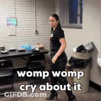 A Woman Walking In A Room With The Words Womp Womp Cry About It GIF