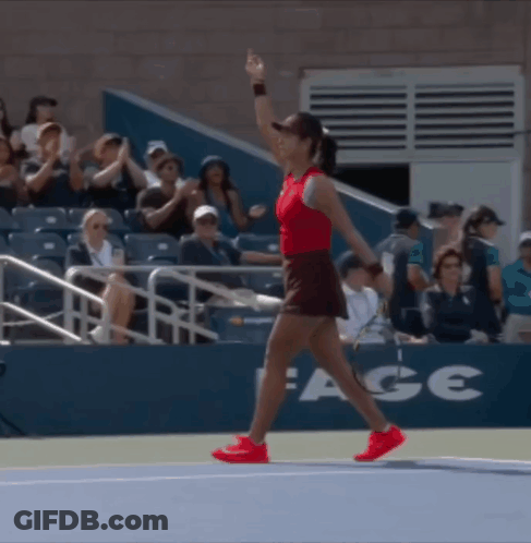 A Woman Walking On A Tennis Court With A Sign That Says Ace GIF