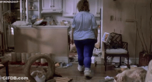 A Woman Walking Through A Messy Kitchen With The Hashtag Trendizisst GIF