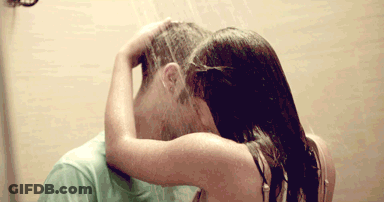 A Woman Washing A Man 'S Hair In A Shower GIF